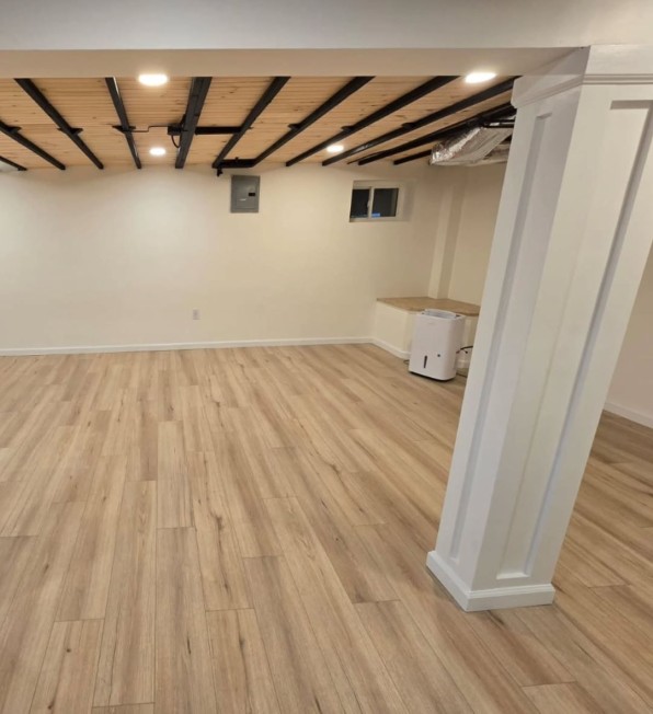 Finished basement with modern finishes by MeyMax Construction LLC