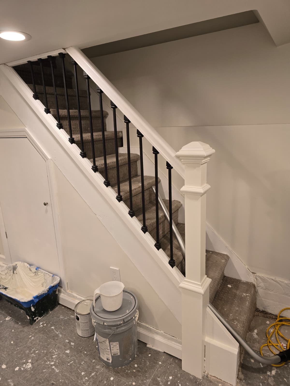 Custom staircase and newel post leading to a finished basement by MeyMax Construction LLC