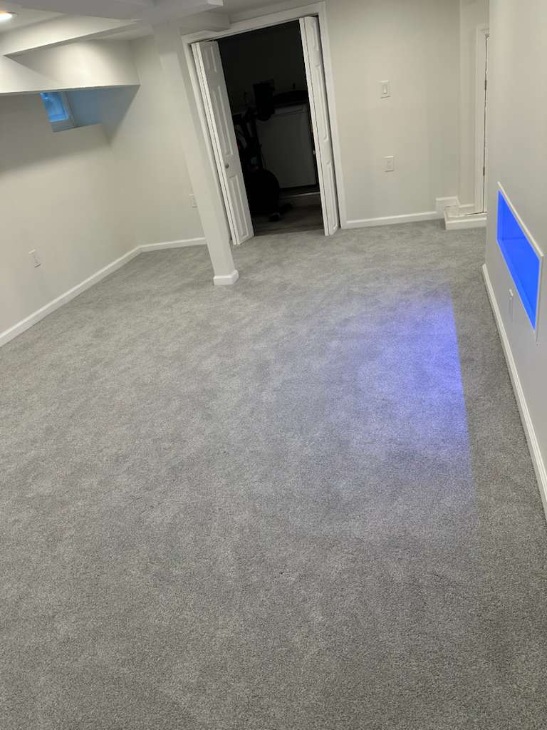 Finished basement with accent lighting by MeyMax Construction LLC